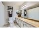 Well-lit bathroom with granite countertops and a full-sized mirror at 6925 Donald Nelson Ave, Las Vegas, NV 89131