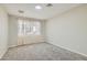 Bright bedroom with neutral carpet, simple window and light walls at 6925 Donald Nelson Ave, Las Vegas, NV 89131