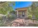 Charming front entrance featuring a stone walkway and covered porch, surrounded by mature desert landscaping at 6925 Donald Nelson Ave, Las Vegas, NV 89131