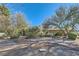 Wide view of the front yard with a stone path, desert landscaping and a partial view of the home at 6925 Donald Nelson Ave, Las Vegas, NV 89131