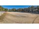 A horse arena with fresh tractor marks shows its large, flat, groomed sandy riding surface, fenced with mature trees beyond at 6925 Donald Nelson Ave, Las Vegas, NV 89131