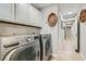 Laundry room featuring a washer, dryer, and white cabinets at 6925 Donald Nelson Ave, Las Vegas, NV 89131