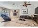 Cozy living room features stone fireplace, wood ceiling fan and a comfortable sitting area at 6925 Donald Nelson Ave, Las Vegas, NV 89131