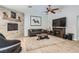 Comfortable living room area features stone fireplace, wood ceiling fan and entertainment center at 6925 Donald Nelson Ave, Las Vegas, NV 89131