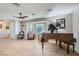 Spacious living room with a piano, neutral walls, tile floors, and a bay window for natural light at 6925 Donald Nelson Ave, Las Vegas, NV 89131