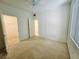 Bedroom featuring carpet, ceiling fan, and doors leading to closet and bathroom at 7123 S Durango Dr # 206, Las Vegas, NV 89113