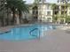 Community pool with ample lounge seating and lush landscaping at 7123 S Durango Dr # 206, Las Vegas, NV 89113