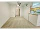 Open-concept living room with neutral carpet, ceiling fan, and view of the entryway and breakfast bar at 7123 S Durango Dr # 206, Las Vegas, NV 89113