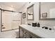 Modern bathroom with a double vanity and shower featuring black hardware and marble countertops at 7250 Diamond Canyon Ln # 204, Las Vegas, NV 89149