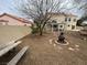 View of a backyard with patio and a fire pit surrounded by gravel landscaping at 7509 Wheat Grass Ct, Las Vegas, NV 89129