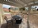 Covered patio area with outdoor seating in the landscaped backyard at 7509 Wheat Grass Ct, Las Vegas, NV 89129