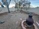 Outdoor living space with a built-in fire pit, a picnic bench, and thoughtful rock and desert landscaping at 7509 Wheat Grass Ct, Las Vegas, NV 89129