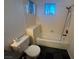 Close up view of a toilet and bathtub in a bathroom with dark flooring at 7509 Wheat Grass Ct, Las Vegas, NV 89129