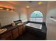 Bathroom featuring a large soaking tub under a stained glass window, dual vanity, and vanity lighting at 7509 Wheat Grass Ct, Las Vegas, NV 89129