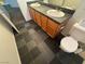 Bathroom featuring dual sinks and dark grey flooring at 7509 Wheat Grass Ct, Las Vegas, NV 89129