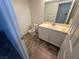 Simple bathroom features a toilet, tile floor, and a vanity at 7509 Wheat Grass Ct, Las Vegas, NV 89129