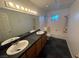 Bathroom with a long vanity with double sinks, and a shower and bath combo at 7509 Wheat Grass Ct, Las Vegas, NV 89129