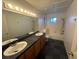 Bright bathroom featuring double sinks, modern fixtures, and a separate tub and shower at 7509 Wheat Grass Ct, Las Vegas, NV 89129