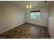 Neutral bedroom with vinyl flooring and window showcasing a view at 7509 Wheat Grass Ct, Las Vegas, NV 89129