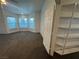 Bright bedroom featuring bay windows, neutral carpeting, and a walk in closet at 7509 Wheat Grass Ct, Las Vegas, NV 89129