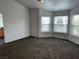 Spacious carpeted bedroom with ample natural light from three large windows at 7509 Wheat Grass Ct, Las Vegas, NV 89129