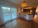 Bright dining area with wooden floors, a kitchen bar and sliding door access to the backyard at 7509 Wheat Grass Ct, Las Vegas, NV 89129