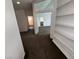 Open hallway featuring built-in shelving and neutral tones, leading to a bathroom and bedroom for accessible living at 7509 Wheat Grass Ct, Las Vegas, NV 89129