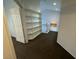 Bright upstairs hallway featuring built-in shelving, neutral walls, and carpet flooring at 7509 Wheat Grass Ct, Las Vegas, NV 89129