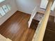 Upstairs view of the hallway featuring hardwood floors, a staircase, and natural lighting at 7509 Wheat Grass Ct, Las Vegas, NV 89129