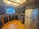 Beautiful kitchen with stainless steel appliances, dark wooden cabinets and a window over the sink at 7509 Wheat Grass Ct, Las Vegas, NV 89129