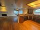 Modern kitchen area with wood floors, an island, and an adjoining living space at 7509 Wheat Grass Ct, Las Vegas, NV 89129