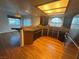 Well-lit kitchen with hardwood floors, a breakfast bar, and modern appliances at 7509 Wheat Grass Ct, Las Vegas, NV 89129