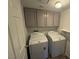 Laundry room features a washing machine and dryer and overhead storage at 7509 Wheat Grass Ct, Las Vegas, NV 89129