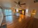 Bright open concept living room with hardwood floors, access to the patio, and views of the modern kitchen at 7509 Wheat Grass Ct, Las Vegas, NV 89129