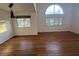 Bright living area with hardwood floors, large windows with shutters, and a modern pendant light fixture above the dining area at 7509 Wheat Grass Ct, Las Vegas, NV 89129