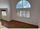 Bright living area with hardwood floors, large windows with shutters, and a modern pendant light fixture above the dining area at 7509 Wheat Grass Ct, Las Vegas, NV 89129