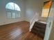 Bright living room featuring high ceilings, wood flooring, and large windows with shutters at 7509 Wheat Grass Ct, Las Vegas, NV 89129