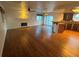 Hardwood floors highlight a living area with a fireplace and a view into the modern kitchen at 7509 Wheat Grass Ct, Las Vegas, NV 89129