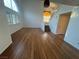 Bright living area with hardwood floors, large windows with shutters, and a modern pendant light fixture above the dining area at 7509 Wheat Grass Ct, Las Vegas, NV 89129