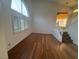 Bright living area with hardwood floors, large windows with shutters, and a modern pendant light fixture above the dining area at 7509 Wheat Grass Ct, Las Vegas, NV 89129