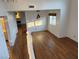 Bright living area with hardwood floors, large windows with shutters, and a modern pendant light fixture above the dining area at 7509 Wheat Grass Ct, Las Vegas, NV 89129