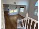 Bright living area with hardwood floors, large windows with shutters, and a modern pendant light fixture above the dining area at 7509 Wheat Grass Ct, Las Vegas, NV 89129