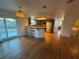 Spacious living room with hardwood floors and a view of the open kitchen with stainless steel refrigerator at 7509 Wheat Grass Ct, Las Vegas, NV 89129