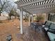 Charming covered patio area with a stone paver floor and outdoor seating to enjoy the beauty of the backyard at 7509 Wheat Grass Ct, Las Vegas, NV 89129