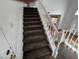 Carpeted stairs with white railing lead to the second floor of the home at 7509 Wheat Grass Ct, Las Vegas, NV 89129