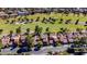 Overhead view of a neighborhood bordering a lush golf course with mature trees and manicured landscaping at 7685 Spanish Bay Dr, Las Vegas, NV 89113