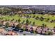 Bird's eye view of a residential area with a well-maintained golf course and mature trees at 7685 Spanish Bay Dr, Las Vegas, NV 89113