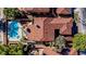 A home is showcased from above, highlighting its kidney-shaped pool, landscaping, and Spanish tile roof at 7685 Spanish Bay Dr, Las Vegas, NV 89113