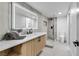 Elegant bathroom with walk-in glass shower, modern vanity, and a large, illuminated mirror at 7685 Spanish Bay Dr, Las Vegas, NV 89113