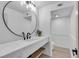 Modern bathroom featuring a vessel sink, round mirror, and elegant white herringbone tile backsplash at 7685 Spanish Bay Dr, Las Vegas, NV 89113